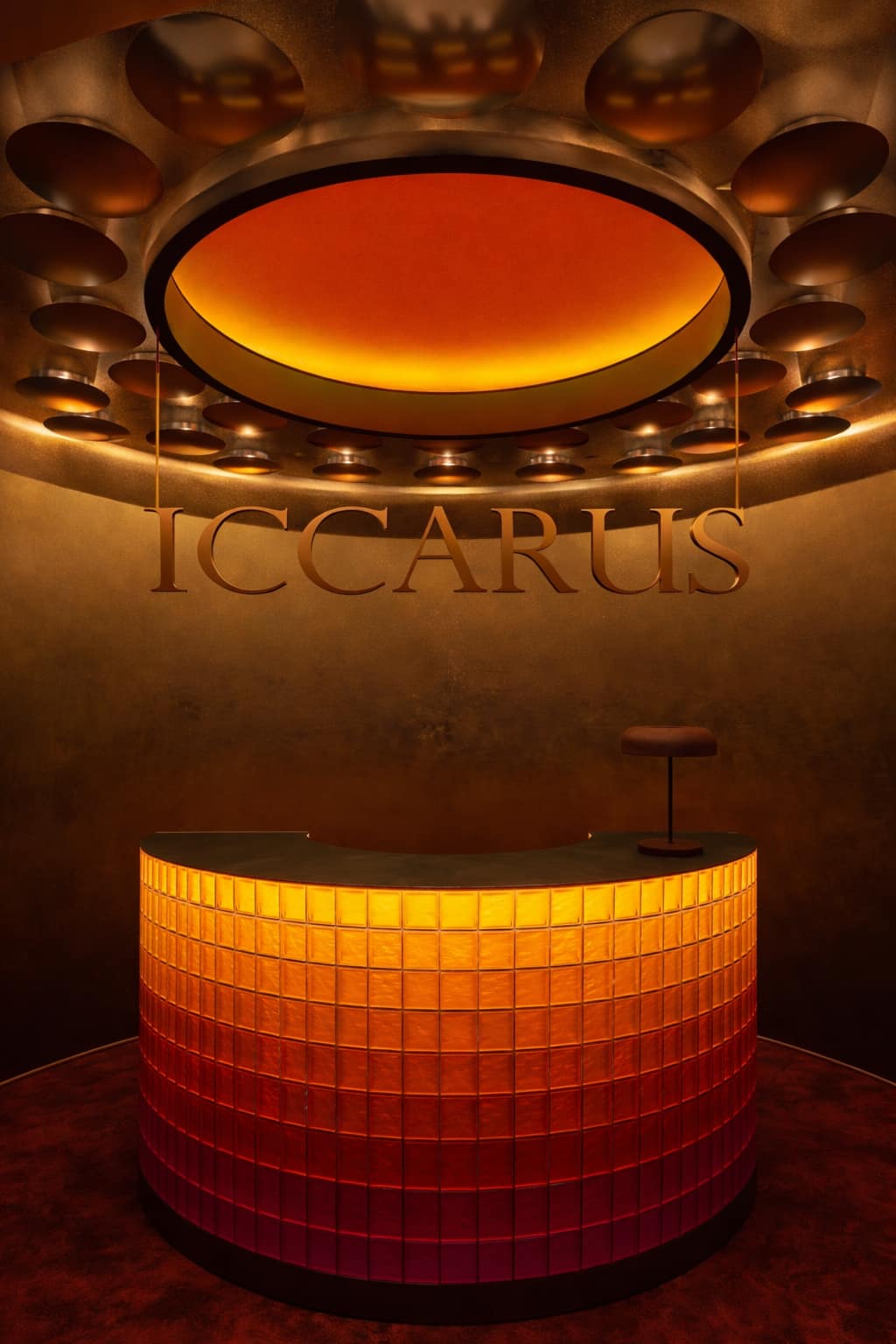 ICCARUS glass-block bar glowing amber.